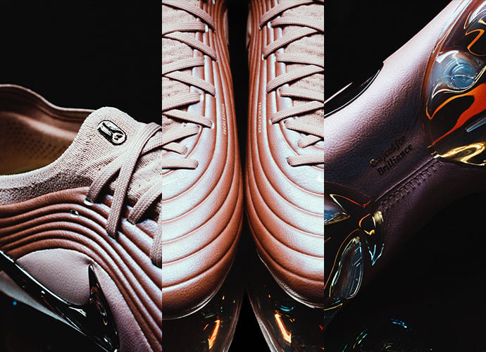 Three premium football boots displayed side by side: white Nike boot with ribbed texture, copper-colored Nike Tiempo Maestro with layered design, and black boot with colorful rainbow accents against dark background