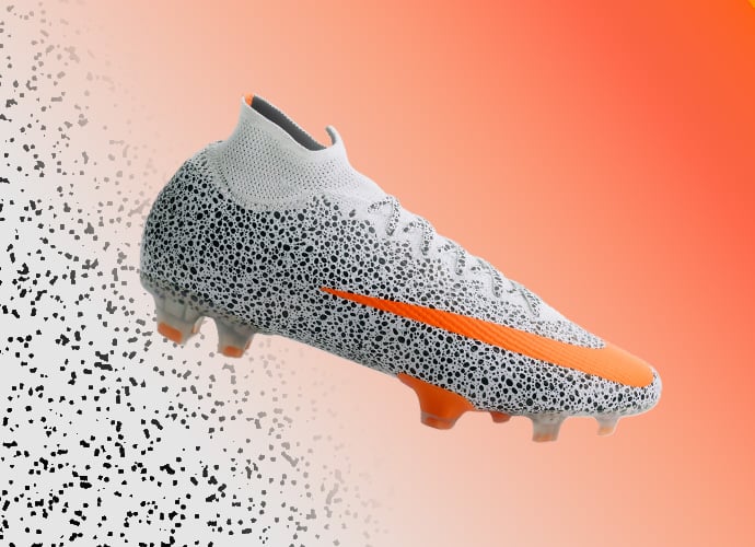 Nike Mercurial Superfly high-top soccer cleat in white with black speckle design, neon orange swoosh branding and matching orange accents