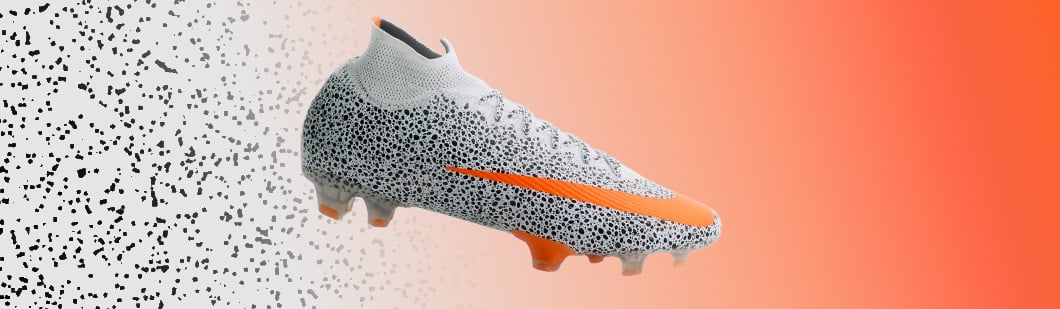 Nike Mercurial Superfly football boot featuring white upper with black dot pattern, orange swoosh and Dynamic Fit collar on geometric background