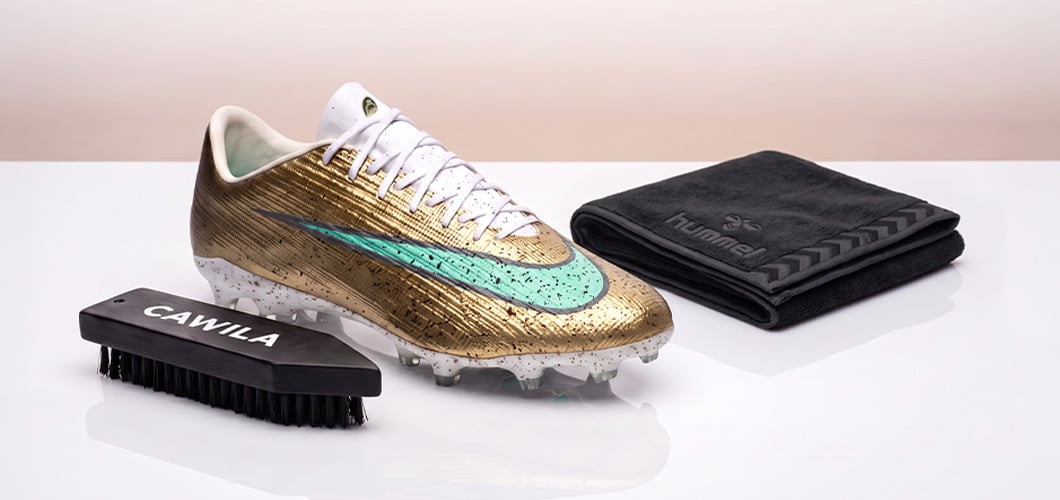 Cleaning a gold Nike football boot with a CAWILA brush and hummel microfibre towel