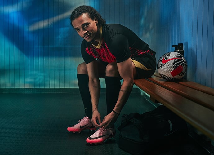 Leroy Sané lacing up his comfortable football boots