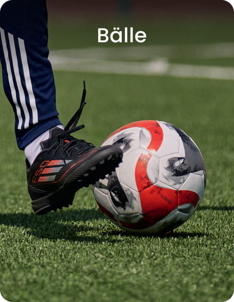 Football player kicking ball on grass - Football balls collection at 11teamsports
