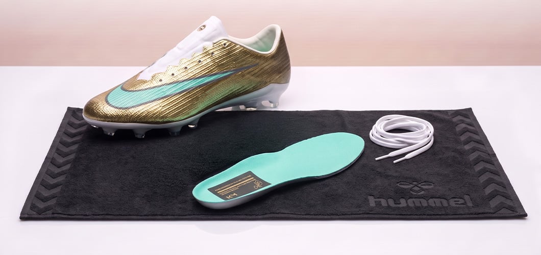 Football boot drying with the insole and laces taken out and laid on a towel