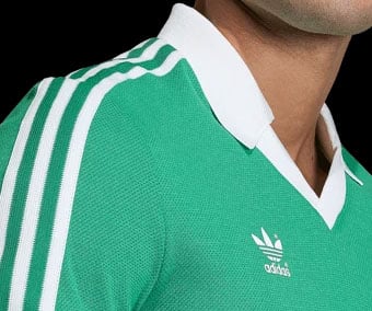 Classic V-neck collar with ribbing and three adidas stripes on shoulder plus pique knit texture closeup