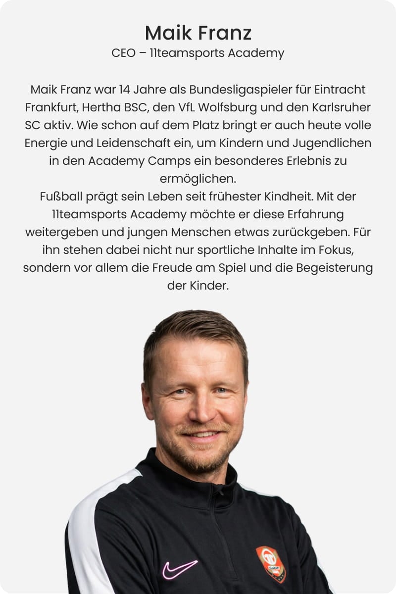 Maik Franz, CEO of 11teamsports Academy and former Bundesliga professional, smiling with arms crossed in black Nike training jacket