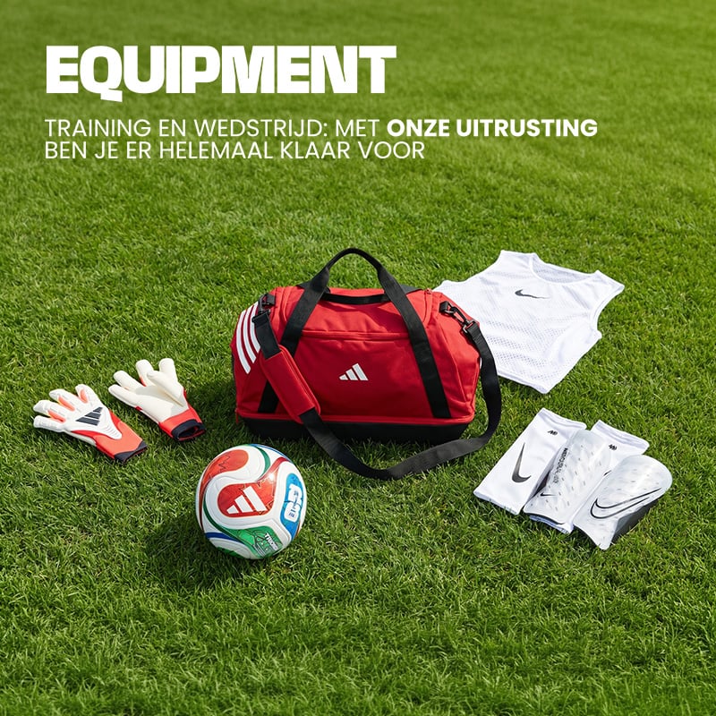 Football equipment on grass including red Adidas sports bag, goalkeeper gloves, football, training bibs and shin guards - Shop football equipment at 11teamsports