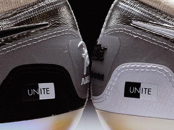 Nike x Patta Vapor 16 UNITE &ndash; detail view of heels facing of each other displaying each the black and white UNITE Logo on the side of the heel cap