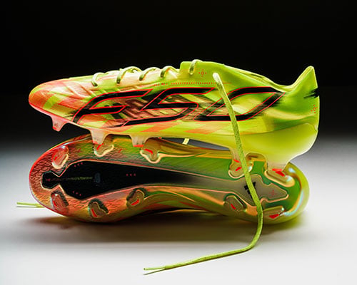 Pair of the adidas F50 Hyperfast Evo Elite FG first launch edition boots arranged: one sideways showing the sole plate. Other boot on top showing lateral inside profile with big F50 logo