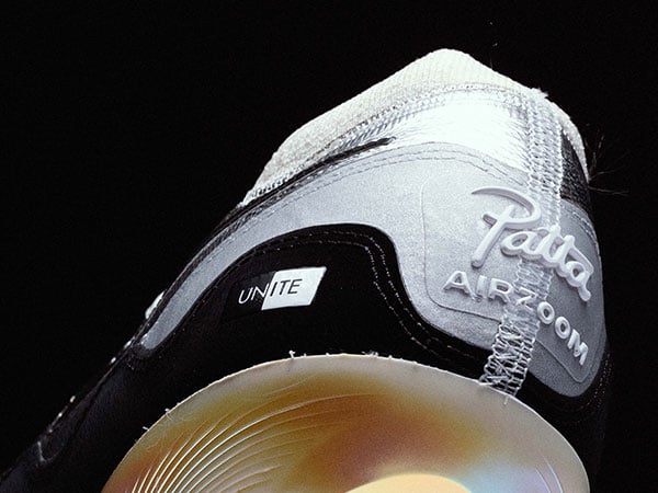 Nike x Patta Vapor 16 UNITE &ndash; detail view on heel with 3D Patta Logo and AIRZOOM font