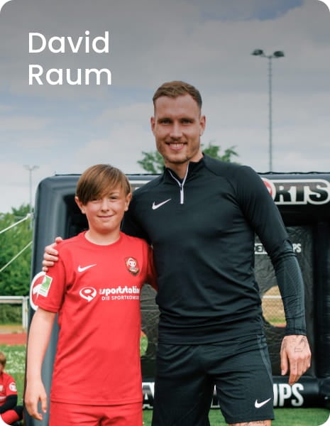 German international David Raum posing with young boy in blue football kit - 11teamsports Football Academy ambassador