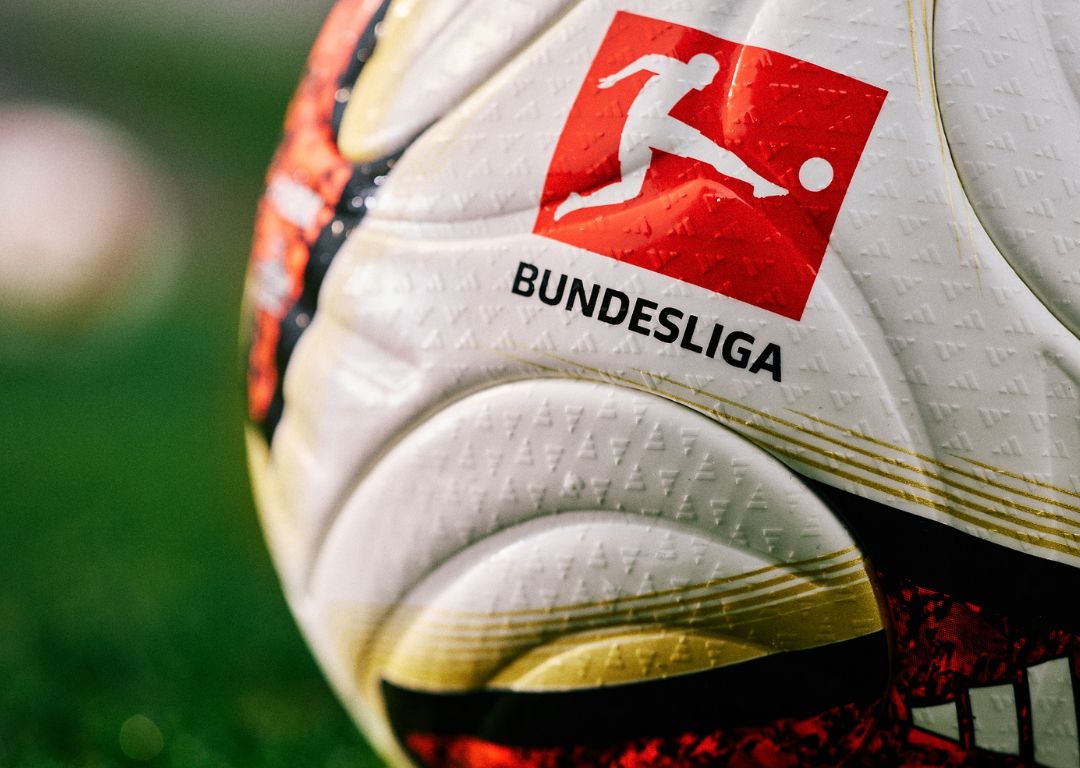 Close-up of adidas Torfabrik football with official Bundesliga logo - white textured surface with gold accents