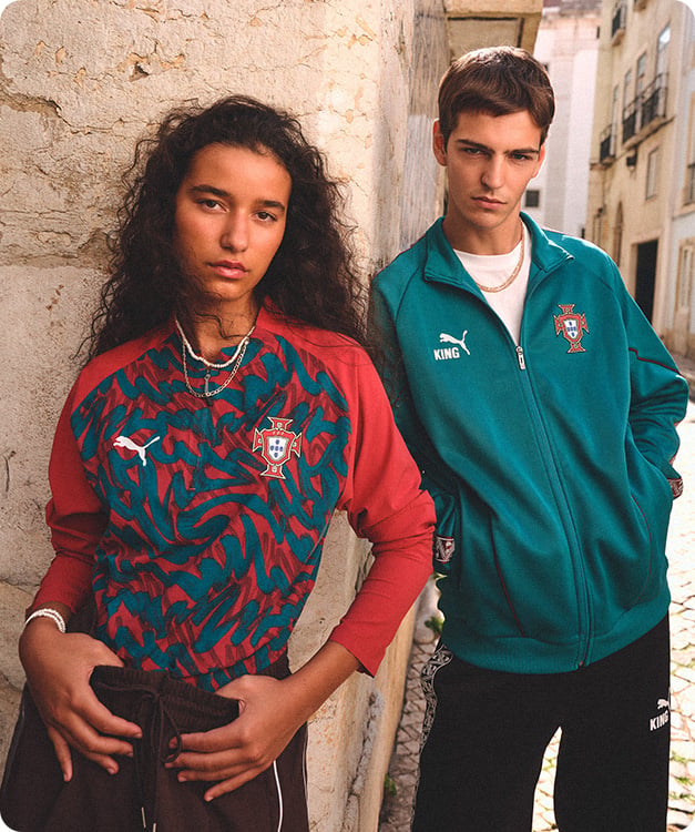 Two models wearing red patterned Portugal pre-match shirt and teal Puma FPF track jacket - Shop Puma Lifestyle at 11teamsports