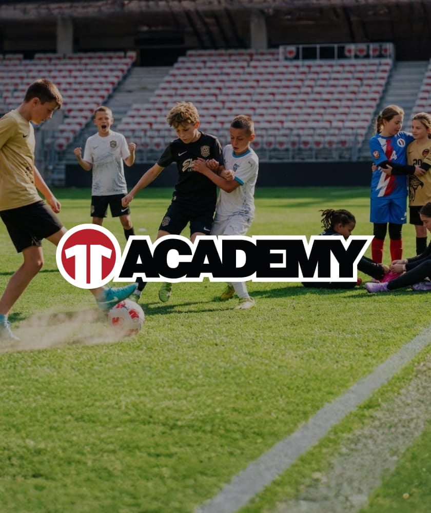 Children playing football on stadium pitch - 11teamsports Academy football camps for kids
