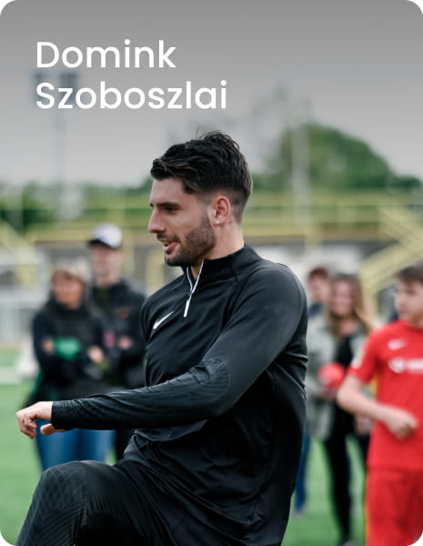 Liverpool FC and Hungary captain Dominik Szoboszlai sitting on football pitch surrounded by young players - 11teamsports Football Academy ambassador