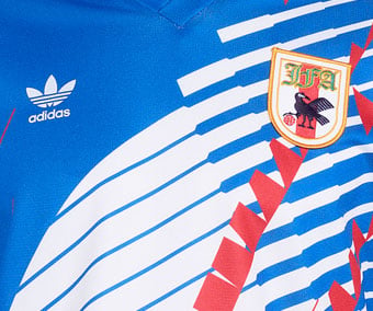 Chest detail with stitched adidas Trefoil logo and sewn-on JFA federation patch