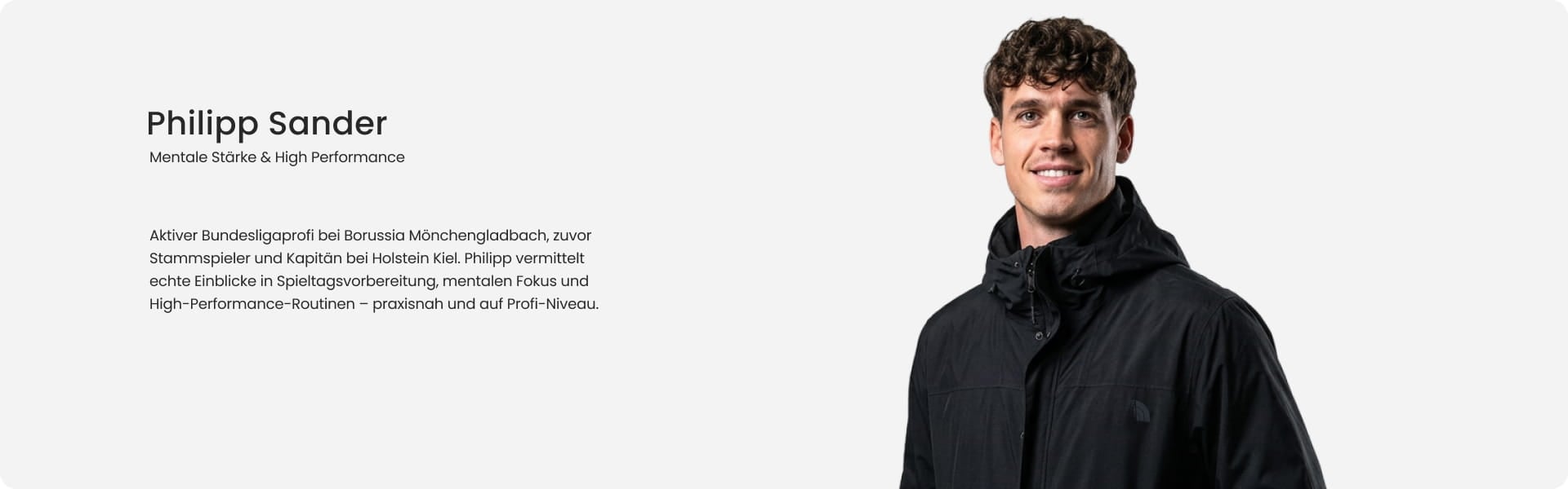 Philipp Sander, Bundesliga professional at Borussia Mönchengladbach and mental strength coach, smiling in black jacket - 11teamsports Football Academy coaching expert