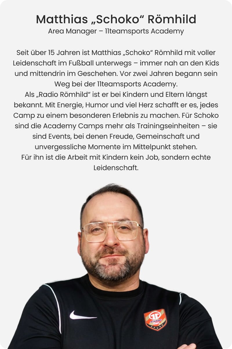 Matthias Schoko Römhild, Area Manager at 11teamsports Academy, smiling with arms crossed in black Nike training jacket with Academy badge