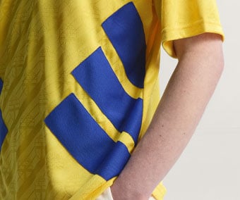 Bold diagonal royal blue adidas 3-stripes running across the side of the Sweden 1994 home jersey