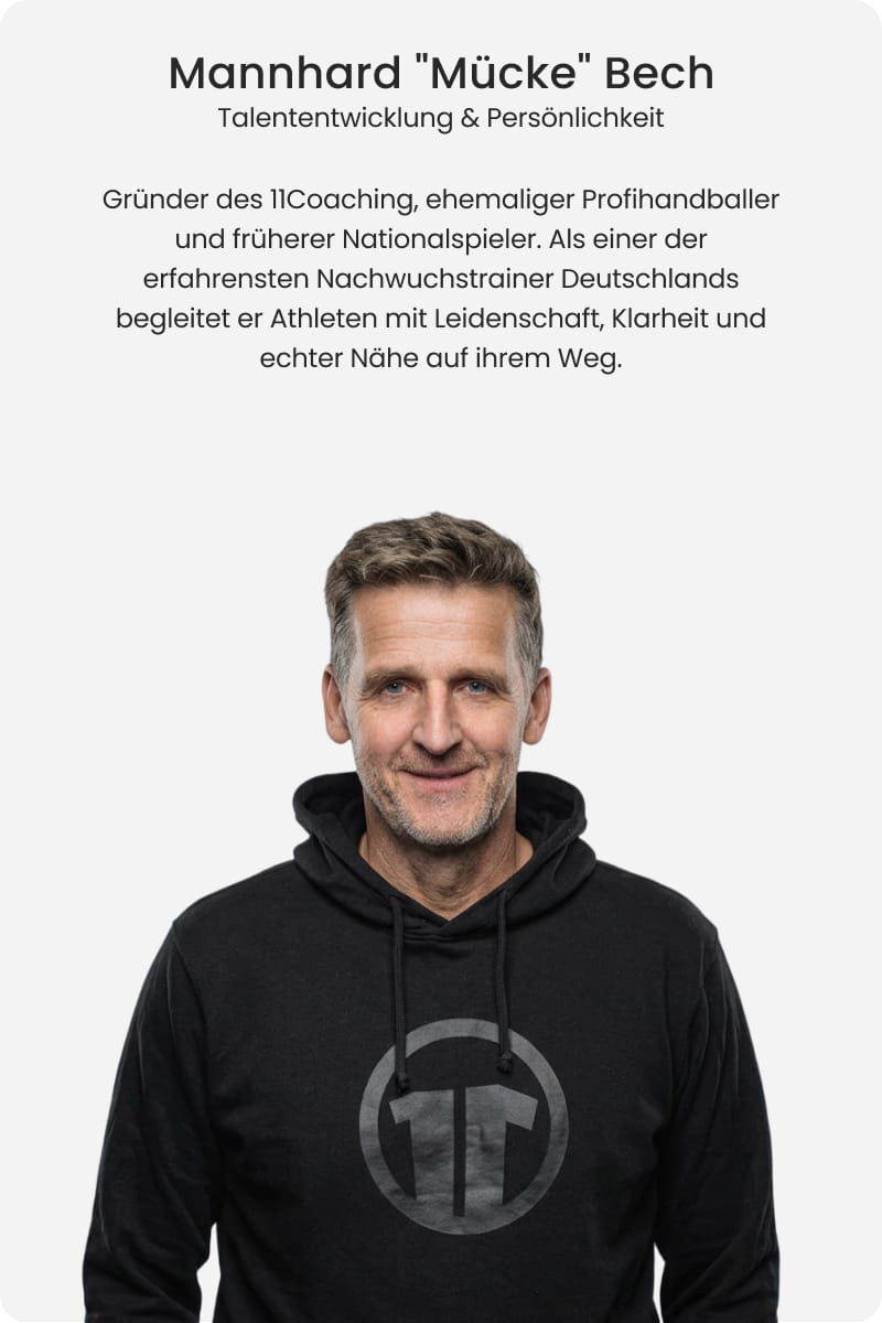 Mannhard Mücke Bech, founder of 11Coaching and former professional handball international, smiling in black 11Coaching hoodie - Talent development and personality expert at 11teamsports Football Academy