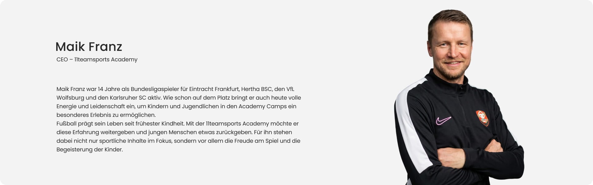 Maik Franz, CEO of 11teamsports Academy and former Bundesliga professional, smiling with arms crossed in black Nike training jacket