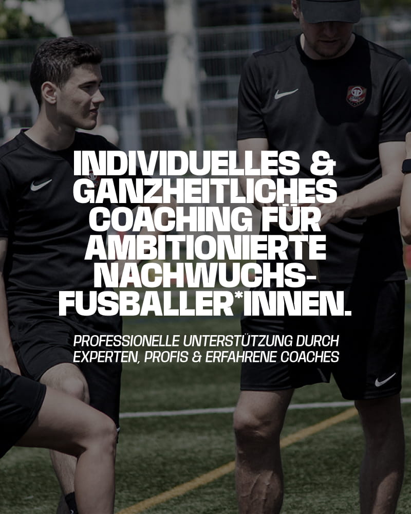 Experienced coaches in black Academy kit discussing tactics with young footballers on pitch - Individual and holistic coaching at 11teamsports Football Academy