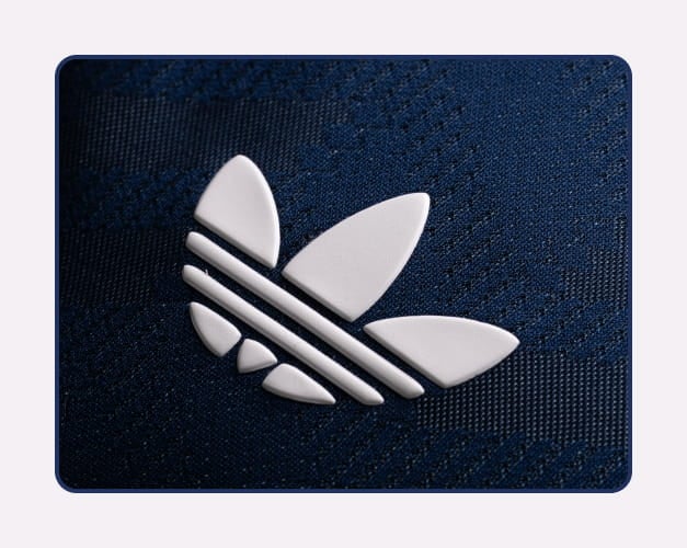 Iconic dark blue Adidas Trefoil on DFB jersey - Historic football emblem since 1954 at 11teamsports