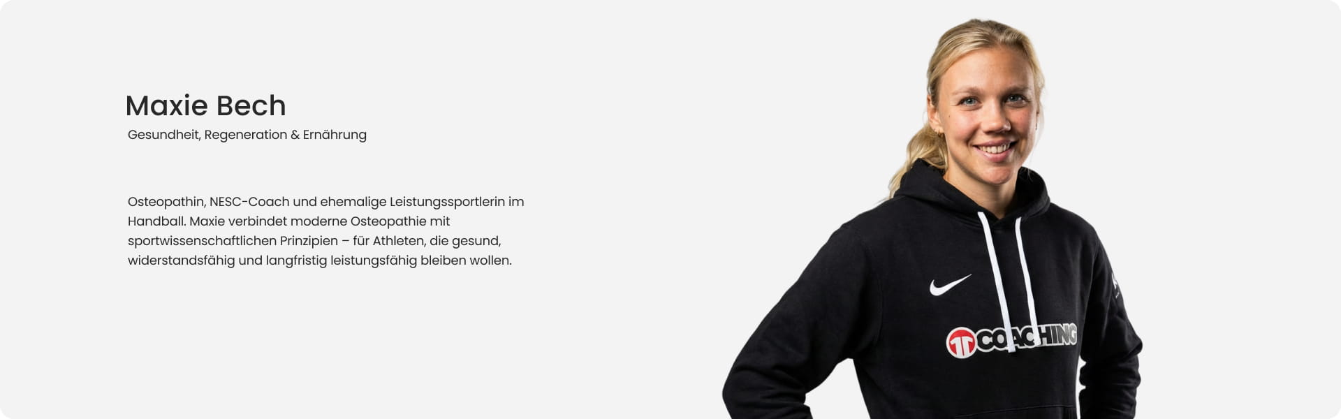 Maxie Bech, osteopath, NESC coach and former professional handball player, smiling in black Nike 11Coaching hoodie - Health, regeneration and nutrition expert at 11teamsports Football Academy