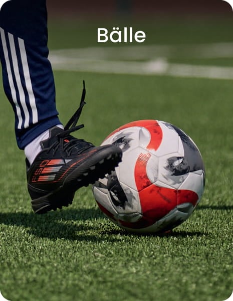 Football player kicking ball on grass - Football balls collection at 11teamsports