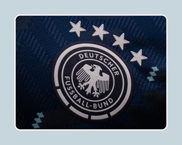 Close-up of Germany national team badge with 4 World Cup stars - DFB eagle emblem at 11teamsports