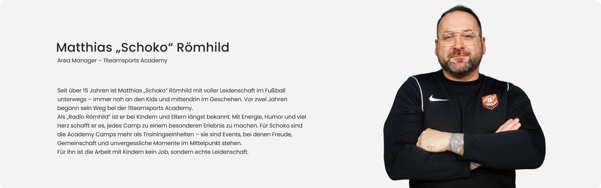 Matthias Schoko Römhild, Area Manager at 11teamsports Academy, smiling with arms crossed in black Nike training jacket with Academy badge